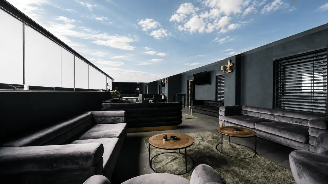 Großzügige Dachterrasse mit Stadtblick bei Dämmerung